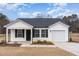 Beautiful single-story home featuring white siding, black shutters, and an attached one car garage at 385 Dasu Dr, Clayton, NC 27520