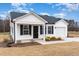 Inviting single-story home with white siding, black shutters, and a well-manicured lawn at 385 Dasu Dr, Clayton, NC 27520