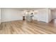 Open-concept living space with hardwood floors, white walls, and a modern kitchen island at 385 Dasu Dr, Clayton, NC 27520