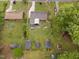 Aerial view showing the property's backyard, mature trees, sheds, and surrounding neighborhood at 3913 Vesta Dr, Raleigh, NC 27603