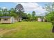 Large backyard with an array of storage sheds and lush greenery offering great opportunities at 3913 Vesta Dr, Raleigh, NC 27603