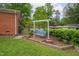 Landscaped backyard featuring a charming wooden swing set and well-maintained lawn at 3913 Vesta Dr, Raleigh, NC 27603