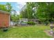 Lush backyard with swing, fountain, mature trees, and landscaping in a residential neighborhood at 3913 Vesta Dr, Raleigh, NC 27603