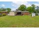 Lush backyard with sheds, manicured lawn, and a covered back porch for outdoor enjoyment at 3913 Vesta Dr, Raleigh, NC 27603