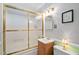 Well-lit bathroom with a frosted glass shower, vanity, and toilet providing a functional space at 3913 Vesta Dr, Raleigh, NC 27603