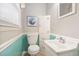 Clean bathroom with a toilet, vanity, mirror, and storage, all well-lit by a window at 3913 Vesta Dr, Raleigh, NC 27603