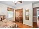 Bedroom with wooden closet doors, hardwood floors, and window at 3913 Vesta Dr, Raleigh, NC 27603