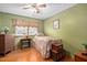 Charming bedroom with a metal bed frame, vintage dresser, and natural light from the window at 3913 Vesta Dr, Raleigh, NC 27603