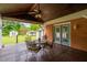 View from a covered wood deck to the back yard, storage sheds, and lush green lawn at 3913 Vesta Dr, Raleigh, NC 27603