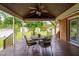 Wood covered deck with dining set overlooking backyard and several storage sheds at 3913 Vesta Dr, Raleigh, NC 27603