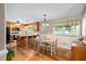 Cozy dining area featuring a breakfast bar, pendant lighting, and a wooden table with unique chairs at 3913 Vesta Dr, Raleigh, NC 27603