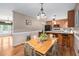 Open concept floor plan showcasing the dining room which features wooden furniture and an adjoining kitchen at 3913 Vesta Dr, Raleigh, NC 27603