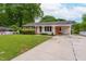 Attractive single-story home with a well-kept lawn, covered carport, and classic brick and siding exterior at 3913 Vesta Dr, Raleigh, NC 27603