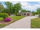Lovely home with long driveway, well-maintained lawn, and a charming garden featuring vibrant azaleas at 3913 Vesta Dr, Raleigh, NC 27603