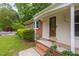 Inviting home entrance with brick accents and manicured garden, showcasing the quaint and traditional design at 3913 Vesta Dr, Raleigh, NC 27603