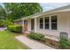 Welcoming home entrance with classic brick accents, landscaped garden and views to the covered parking at 3913 Vesta Dr, Raleigh, NC 27603