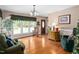 Comfortable living room showcasing natural light from a large window, hardwood floors, and a decorative accent chest at 3913 Vesta Dr, Raleigh, NC 27603