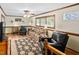 Living room with a ceiling fan, wood paneled walls, a patterned area rug and comfortable seating at 3913 Vesta Dr, Raleigh, NC 27603