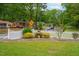 Charming neighborhood street view with manicured lawns and quaint homes behind a white picket fence at 3913 Vesta Dr, Raleigh, NC 27603
