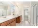 Bright bathroom featuring a double vanity, large mirror, and a glass-enclosed shower at 3917 White Kestrel Dr, Raleigh, NC 27616
