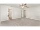 Bedroom with carpet, ceiling fan, and multiple doors leading to other rooms and the bathroom at 3917 White Kestrel Dr, Raleigh, NC 27616