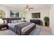 Main bedroom features a contemporary bed, a ceiling fan, carpet, and a TV at 3917 White Kestrel Dr, Raleigh, NC 27616