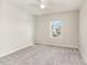 Bright bedroom with neutral carpet, a ceiling fan, and a window at 3917 White Kestrel Dr, Raleigh, NC 27616