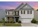 Two-story home featuring stone accents, gray and white siding and shutters, and a two-car garage at 3917 White Kestrel Dr, Raleigh, NC 27616