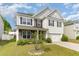 Two-story home featuring stone accents, gray and white siding and shutters, and a two-car garage at 3917 White Kestrel Dr, Raleigh, NC 27616