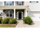 Inviting front porch with stone accents and columns, leading to a black front door at 3917 White Kestrel Dr, Raleigh, NC 27616