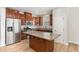 Kitchen features stainless steel appliances, dark wood cabinets, granite countertops, and a kitchen island at 3917 White Kestrel Dr, Raleigh, NC 27616
