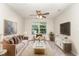 Elegant living room with stylish furniture, a ceiling fan, and ample natural light at 3917 White Kestrel Dr, Raleigh, NC 27616