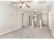 Bright living area featuring a ceiling fan, neutral walls, and access to multiple rooms at 3917 White Kestrel Dr, Raleigh, NC 27616