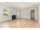 A cozy living room features wood flooring and a traditional fireplace with white mantle at 3917 White Kestrel Dr, Raleigh, NC 27616