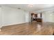 Open layout connects the living room to kitchen, enhancing space with wood floors and natural light at 3917 White Kestrel Dr, Raleigh, NC 27616