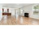 Spacious living room with fireplace, wood flooring, and open layout to kitchen at 3917 White Kestrel Dr, Raleigh, NC 27616