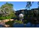 Serene pond reflecting modern architecture and lush greenery, enhancing the community's appeal at 408 Madison Ave, Cary, NC 27513