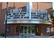 Classic brick theater facade with a vintage marquee displaying current showtimes and upcoming events at 408 Madison Ave, Cary, NC 27513