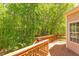 Inviting back deck featuring wood flooring and railing with peaceful views of mature trees and lush greenery at 413 Palafox Dr, Chapel Hill, NC 27516