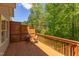 Relaxing back deck featuring wood floors, privacy lattice, table and chairs, and peaceful views of lush greenery at 413 Palafox Dr, Chapel Hill, NC 27516