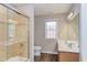 Bright bathroom featuring a glass enclosed shower, wood floors, and a large vanity mirror at 413 Palafox Dr, Chapel Hill, NC 27516