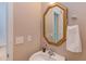 Cozy half bathroom featuring traditional fixtures, decorative mirror, and a stylish sink at 413 Palafox Dr, Chapel Hill, NC 27516