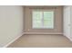 Comfortable bedroom featuring carpet, neutral walls, and ample natural light from a large window at 413 Palafox Dr, Chapel Hill, NC 27516