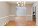 Elegant dining room featuring hardwood floors, chair rail molding and an arched entryway at 413 Palafox Dr, Chapel Hill, NC 27516