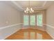 Dining room with hardwood floors, bay windows, and a modern chandelier at 413 Palafox Dr, Chapel Hill, NC 27516
