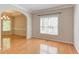 Open dining room with hardwood floors and arched doorway, bathed in natural light at 413 Palafox Dr, Chapel Hill, NC 27516
