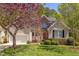Charming two-story home with a well-manicured lawn, a brick facade, and lush landscaping at 413 Palafox Dr, Chapel Hill, NC 27516