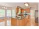 Open kitchen with a large island, stainless steel appliances, and hardwood floors at 413 Palafox Dr, Chapel Hill, NC 27516
