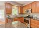 Modern kitchen with stainless steel appliances, granite counters, and wood cabinetry at 413 Palafox Dr, Chapel Hill, NC 27516