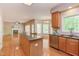 Open-concept kitchen with an island, stainless appliances, and hardwood floors flowing into living areas at 413 Palafox Dr, Chapel Hill, NC 27516